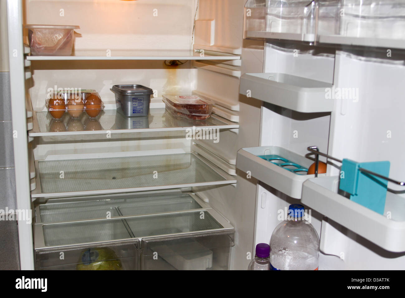 Sparse fridge interior with little food Stock Photo