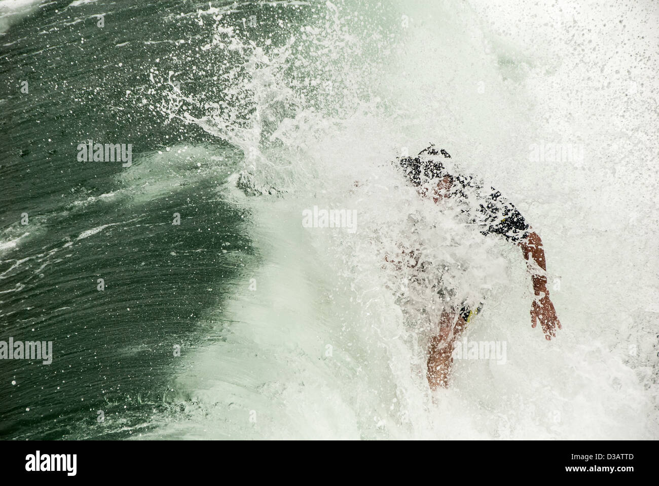 California surfer holds his line in an explosion of whitewater at Manhattan Beach. Stock Photo