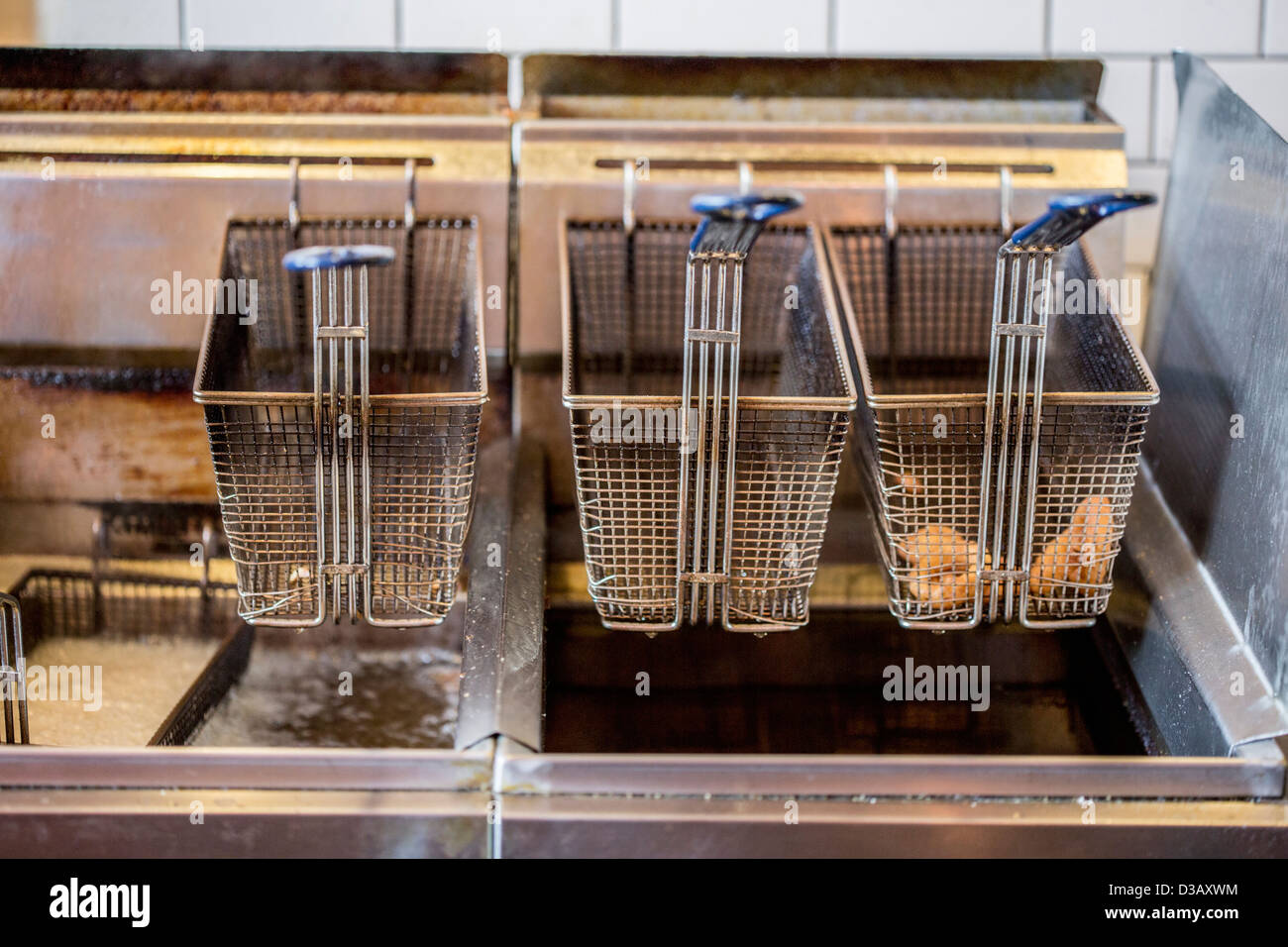 Baskets on deep fat fryer in restaurant Stock Photo Alamy