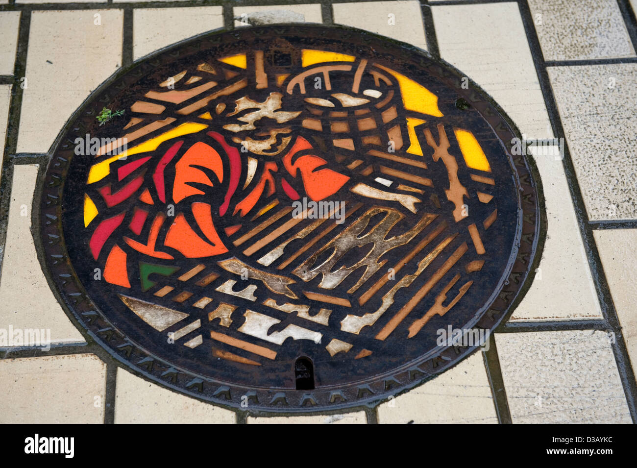 Manhole cover art depicting traditional Japanese washi paper making in the town of Takefu in Fukui Prefecture. Stock Photo