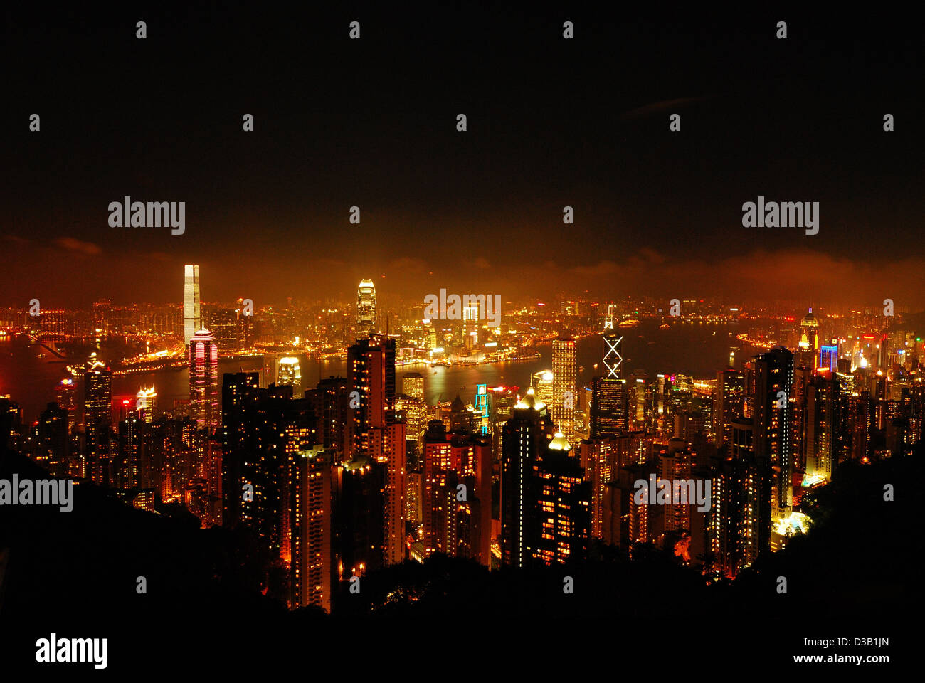 Night view of Hong Kong City from the top of the hill looking down to the skyscraper and river. Stock Photo