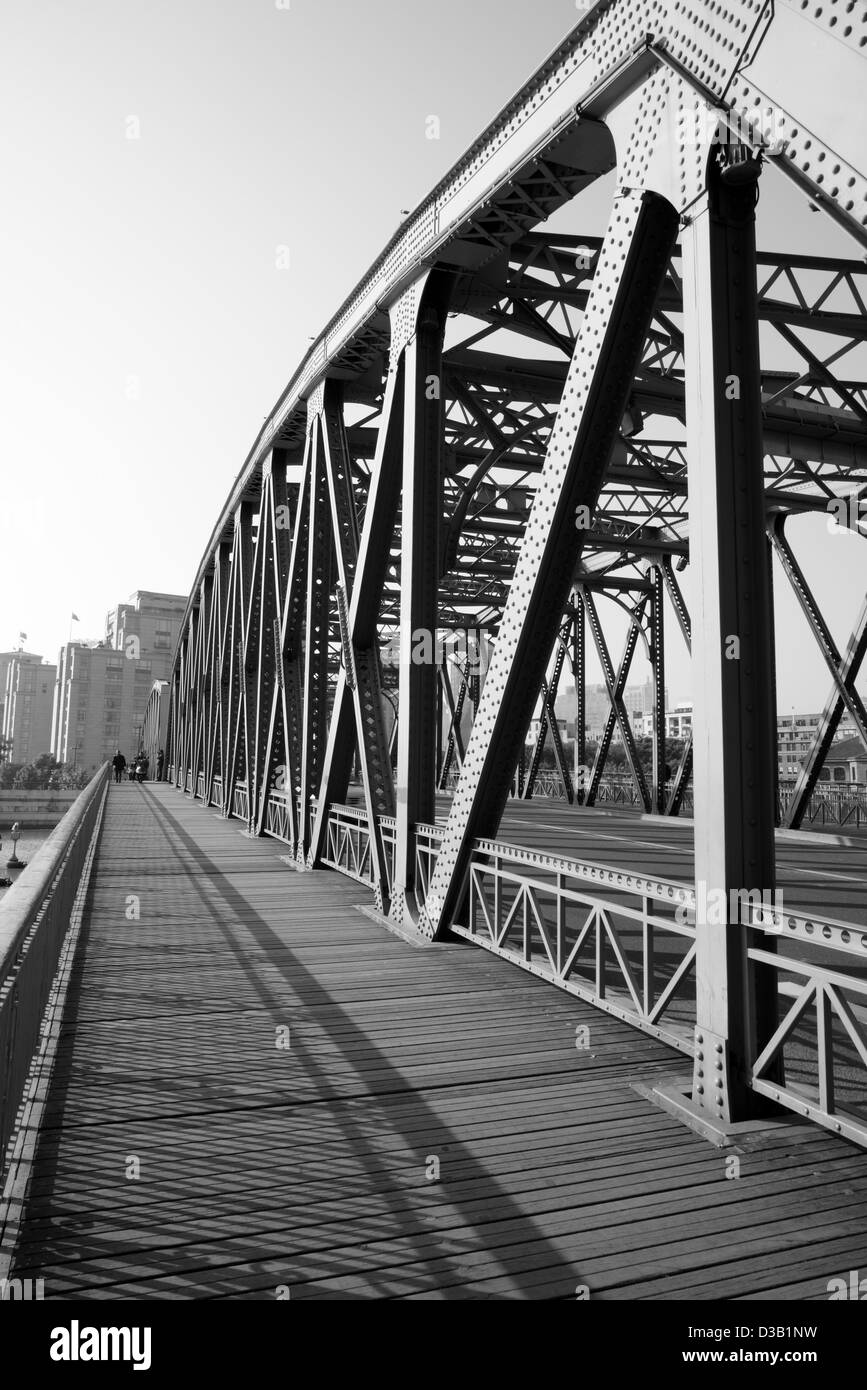 Black and white scenery of an old steel bridge for pedestrian and vehicle. Stock Photo