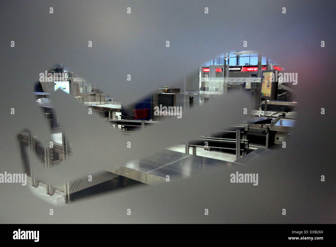 Cologne, Germany. 15th February 2013. An empty security check can be seen through an aircraft symbol on a window inside the airport in Cologne, . The security personnel of the Cologne-Bonn Airport is on strike. Most flights are cancelled. Photo: Oliver Berg/dpa/Alamy Live News Stock Photo