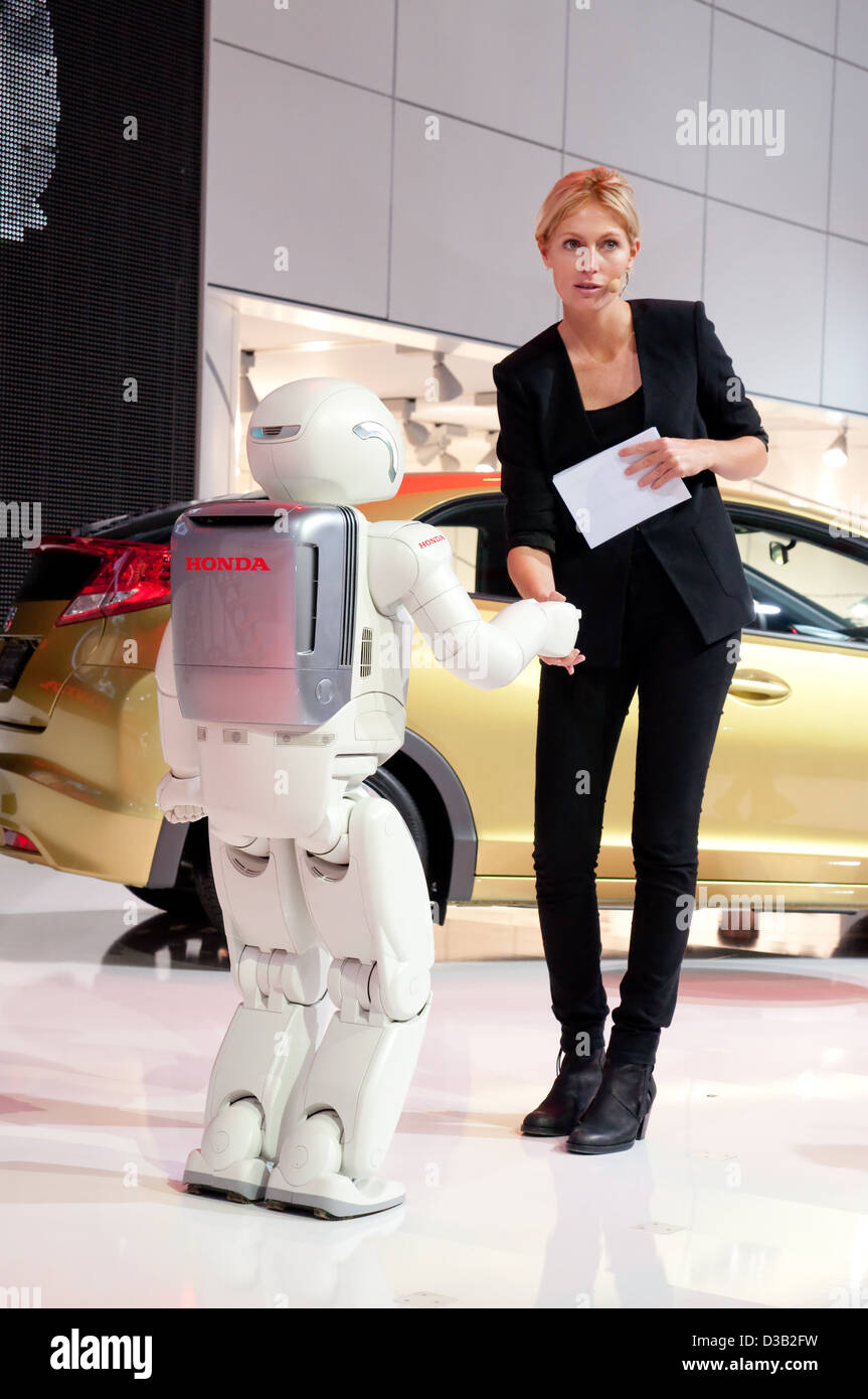 Asimo, The Super Intelligent Humanoid Robot is just shaking hand with a lady at the 64th Internationale Automobil Ausstellung (I Stock Photo