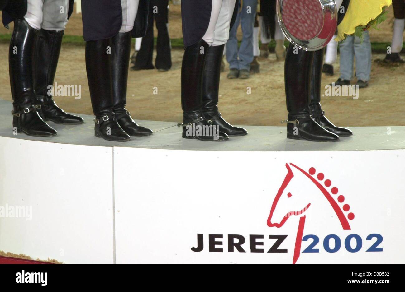(dpa) - The boots of the German dressage equipe are seen as the riders stand on the podium, at the World Equestrian Games in Jerez, Spain, 12 September 2002. L-R: Klaus Husenbeth, Ulla Salzgeber, Nadine Capellmann and Ann Kathrin Linsenhoff. Stock Photo