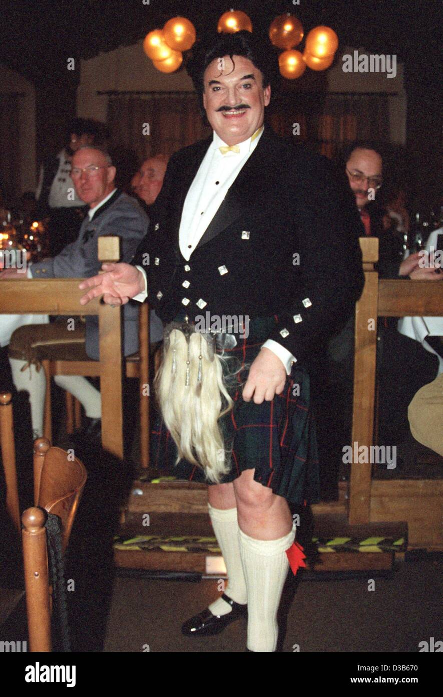 (dpa files) - Rudolph Moshammer, eccentric German fashion designer, wears a Scottish kilt and stockings at the Filserball, a carnival party, in Munich, 26 February 2000. After an apprenticeship in a textile company, Moshammer started his career at Christian Dior in Paris. In 1967 he opened, together Stock Photo