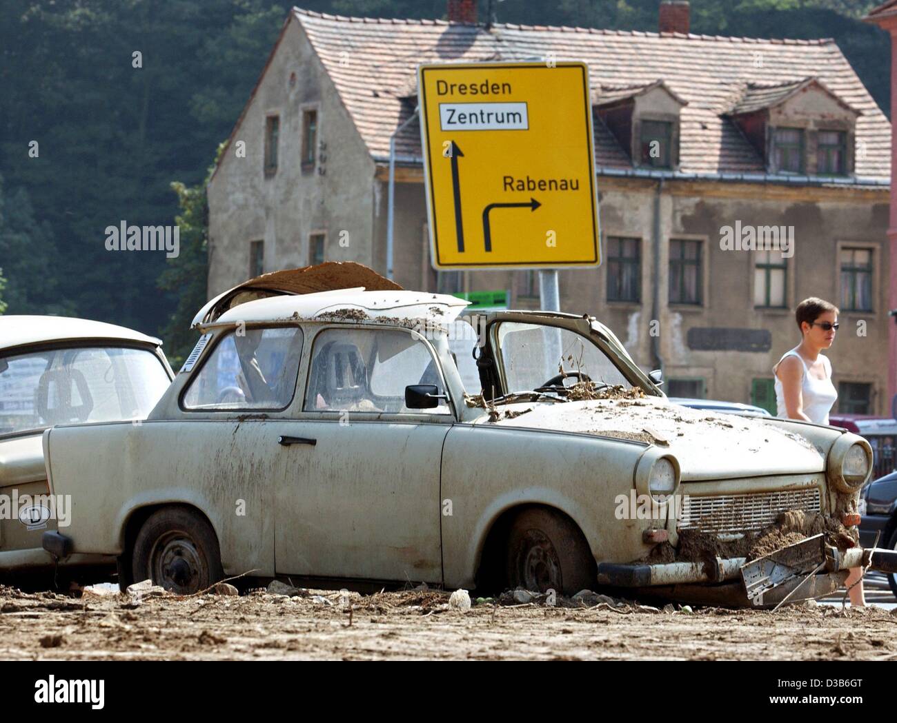 (dpa) - A devastated Trabant ('Trabi') car, destroyed by the floods in eastern Germany, stands in Freital, Germany, 25 August 2002. Ten days after the flood the residents are tired and take a break over the weekend from shoveling mud and cleaning up. Most of the shops are still closed. Stock Photo