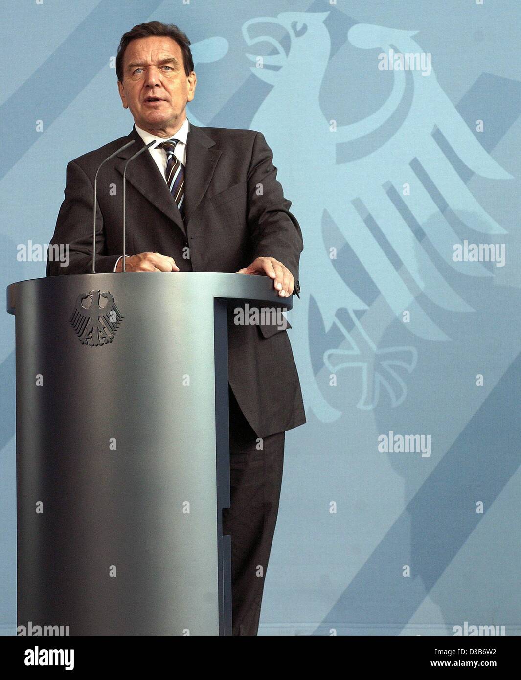 (dpa) - Chancellor Gerhard Schroeder comments on the plans to reduce unemployment in Germany in front of the Federal Eagle logo in the chancellor's office in Berlin, 9 August 2002. Stock Photo