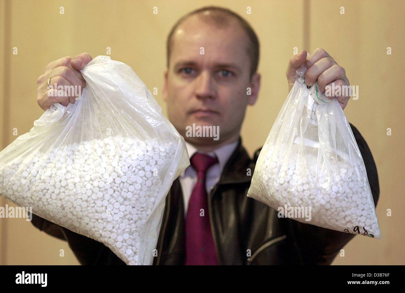 (dpa) - A police spokesman shows two bags of ecstasy pills in the police department in Frankfurt, 23 December 2002. The drugs were confiscated from a group of Dominican dealers in Frankfurt. Stock Photo