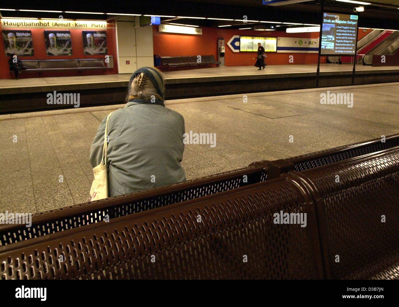 (dpa) - An elderly woman waits for the tube in vain at the underground station at the central train station in Stuttgart, Germany, 17 December 2002. Before a new round of negotiations the trade union Ver.di called for short warning strikes and brought the public transport in several German cities to Stock Photo