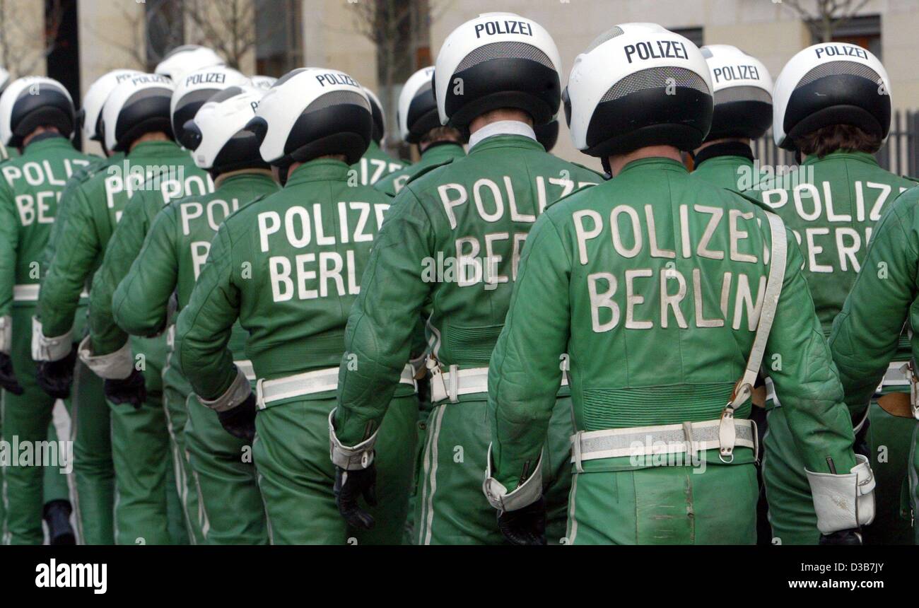 (dpa) - Members of the motor-bike squad of Berlin's police walk in line in Berlin, 18 December 2002. Before, 100 new police cars were handed over at the Brandenburg Gate. The BMW police-cars with diesel-engines have been leased for two years and are going to enrich the rolling stock. Whereas the pol Stock Photo