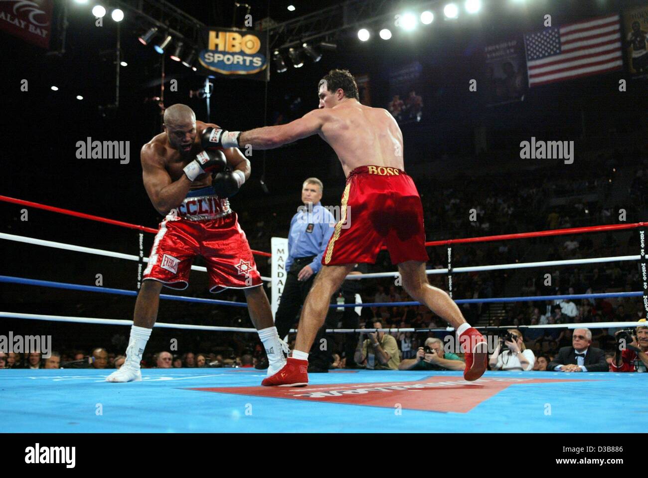 The heavyweight boxer Wladimir Klitschko (right) drives a punch towards his opponent  the US boxer Jameel McCline during the WBO heavyweight title fight on 8 December 2002 in Las Vegas. The Ukranian Wladimir Klitschko knocked out his opponent with a technical Ko. in the tenth round and defended his  Stock Photo