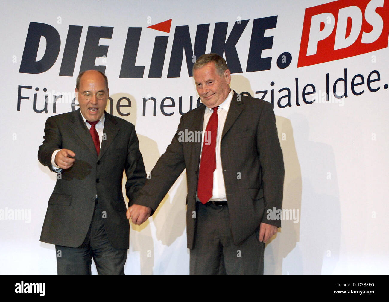 The Chairman of the German left-wing party PDS Lothar Bisky (R) and the PDS politician Gregor Gysi enter hand in hand the stage for the extraordinary party conference of the PDS in Berlin, Germany, Sunday 17 July 2005. The party renamed as 'Die Linkspartei' (The left party). It is to lay foundations Stock Photo