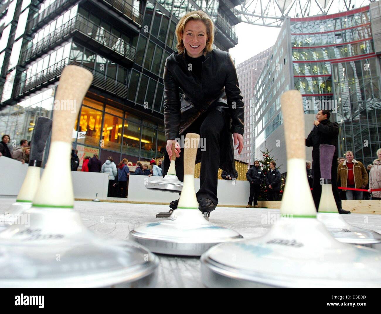 (dpa) - German speed skater Claudia Pechstein plays curling on the ice rink in the Sony Center in Berlin, 29 November 2002. Visitors can currently try out curling on two original Austrian ice rinks that are mounted in the Sony Center. Stock Photo