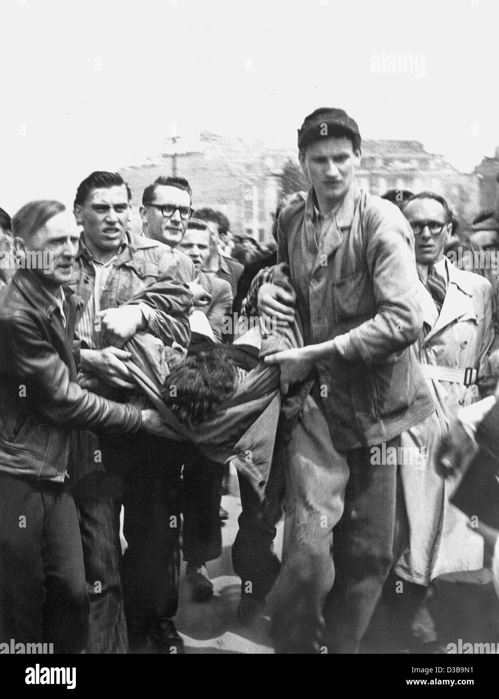 (dpa files) - A demonstrator killed by Soviet tanks is carried away, during the riots against the communist regime in East Berlin, 17 June 1953. The uprising escalated when strikes and a demonstration against unreasonable production quotas were knocked down by Soviet tanks and troops on 17 June. Stock Photo