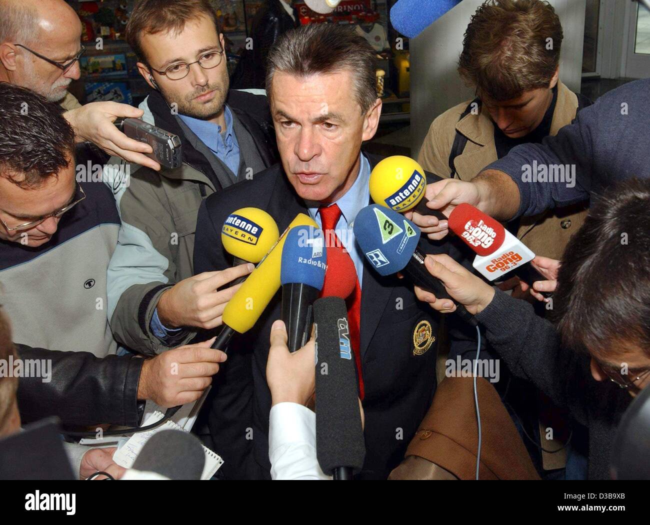 (dpa) - Ottmar Hitzfeld, coach of the German soccer club FC Bayern Munich, is surrounded by journalists at his departure to Milan at the airport in Munich, 22 October 2002. The next day, Bayern faces AC Milan for the Champions League Group G match. Stock Photo