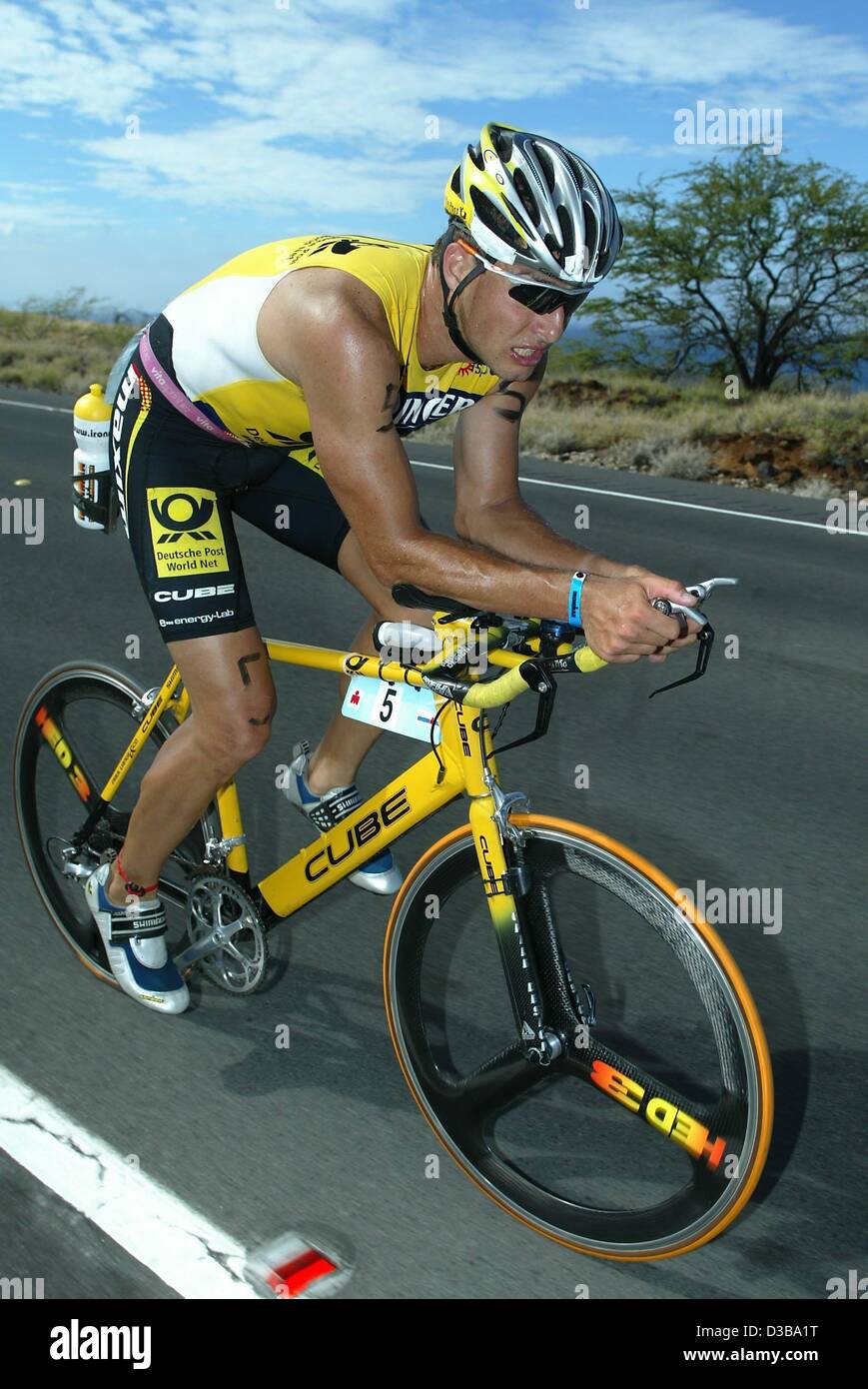 (dpa) - German athlete Lothar Leder cycles through the lava desert during the Ironman Triathlon World Championship in Kailua-Kona, Hawaii, 19 October 2002. Leder, who was one of the favorites to win, placed 38th in the end. Stock Photo