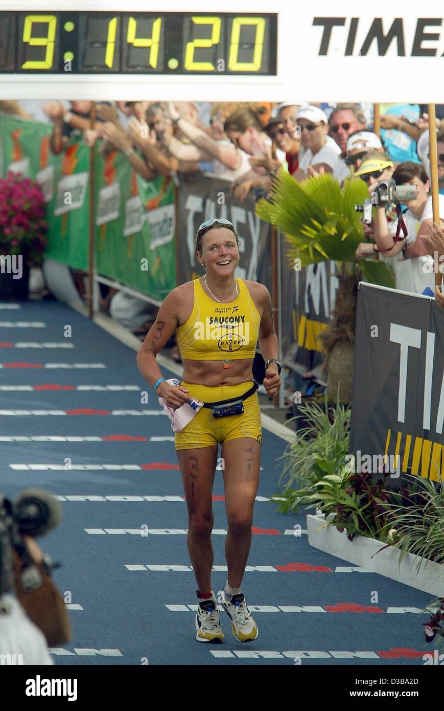 (dpa) - German athlete Nina Kraft arrives second at the finish line of the Women's Ironman Triathlon World Championship in Kailua-Kona, Hawaii, 19 October 2002. Kraft completed the course of 3.8 km swimming, 180 km cycling and a marathon in 9 hours, 14 minutes and 24 seconds. Stock Photo