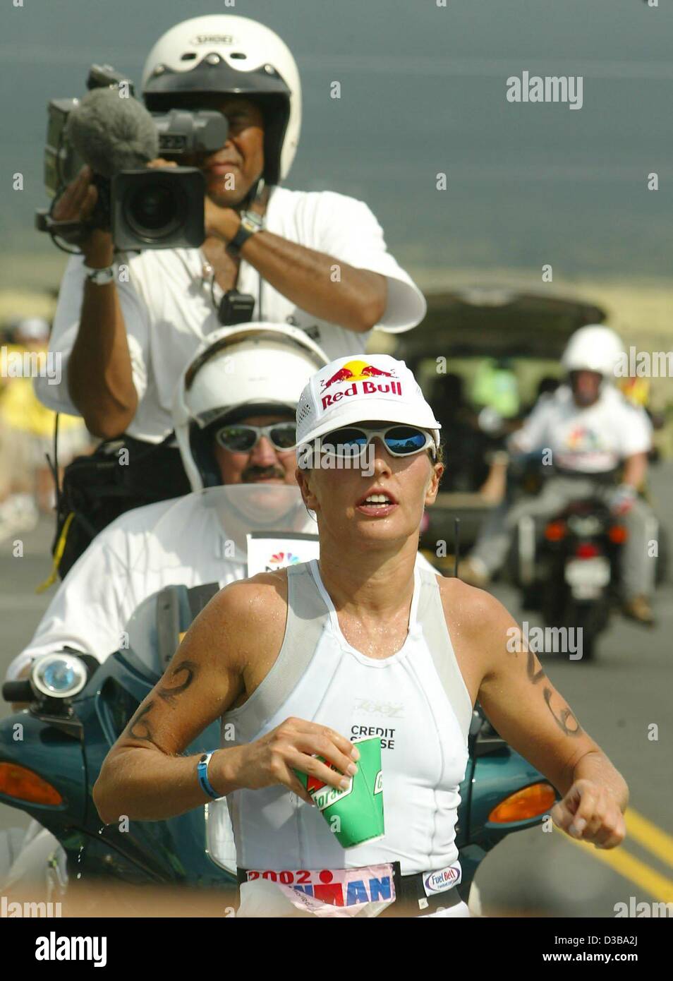 dpa) - Swiss athlete Natascha Badmann is followed by a camerateam as she  runs during the Women's Ironman Triathlon World Championship in  Kailua-Kona, Hawaii, 19 October 2002. Badmann won first place by