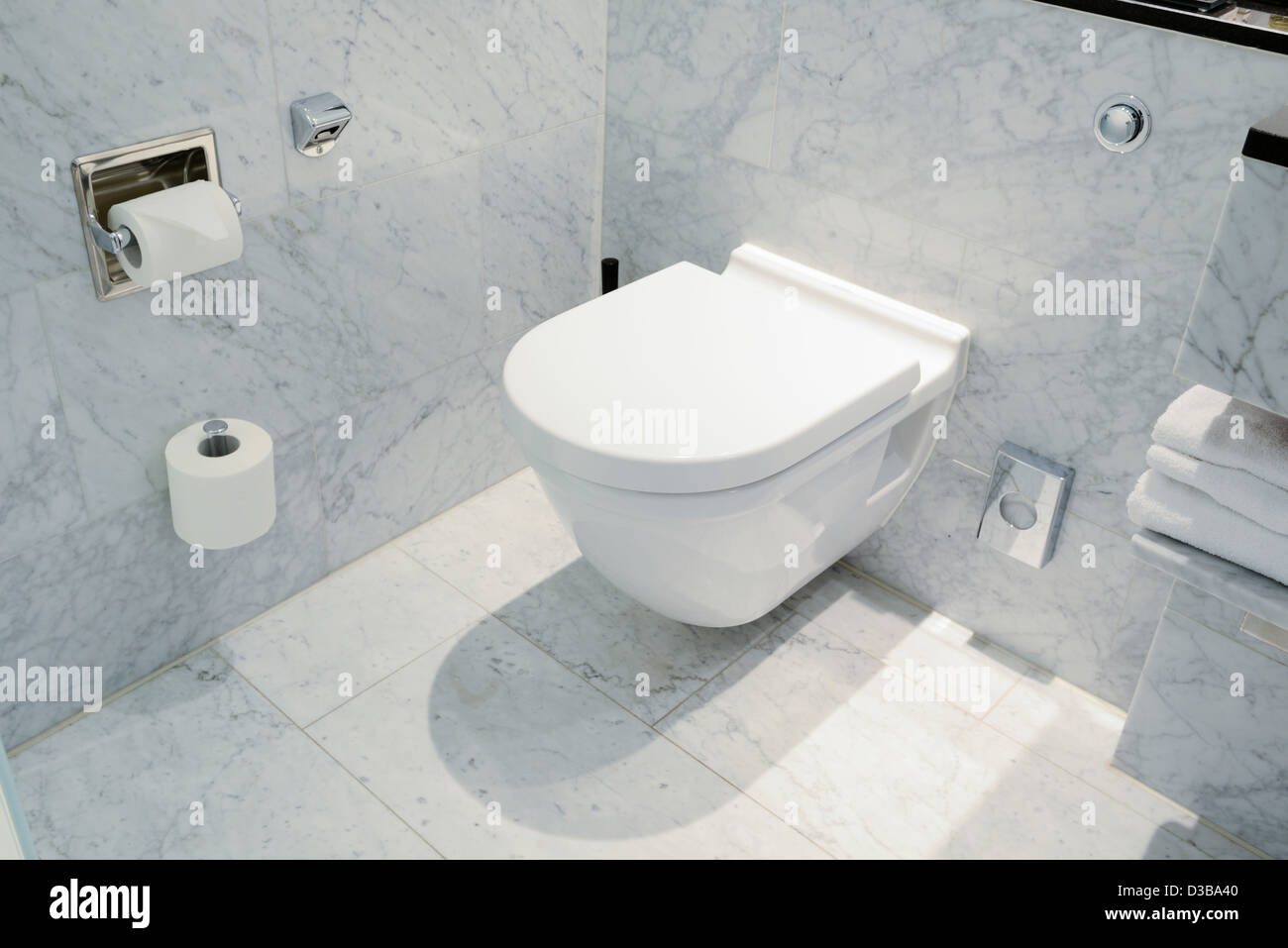 Smart wall mounted toilet in marble bathroom Stock Photo