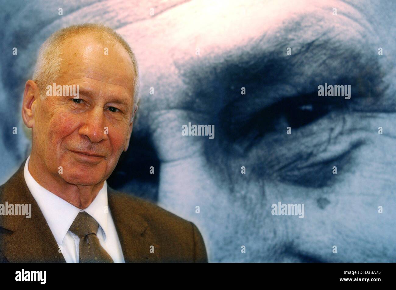 (dpa) - Markus Wolf, former spy for the German Democratic Republic (GDR), poses in front of his portrait at the Book Fair in Frankfurt, 9 October 2002. At the book fair he presented his new book entitled 'Freunde sterben nicht' (friends don't die), in which he narrates his encounters with German, Ru Stock Photo