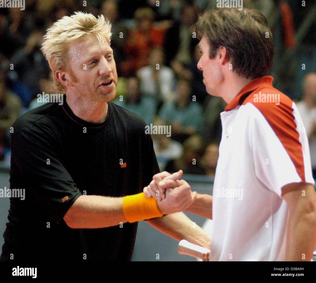 (dpa) - Boris Becker (L) congratulates winner Michael Stich after the semi final tennis match of the 'Delta Tour of Champions' in Frankfurt, 23 November 2002. Stich won in two sets 6-3 and 6-4. The night before, both had celebrated Becker's 35th birthday until the early morning. Stock Photo
