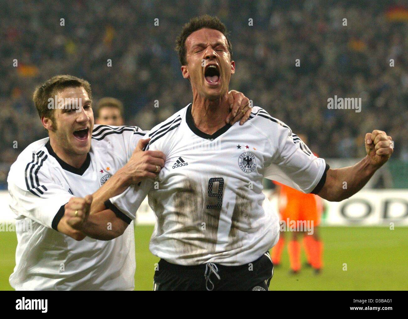 (dpa) - German goal scorer Fredi Bobic (R) jubilates with his team mate Torsten Frings during the international friendly soccer match Germany against Netherlands in Gelsenkirchen, Germany, 20 November 2002. Holland went on to win 3-1. It is Germany's first defeat since the World Cup final. Stock Photo