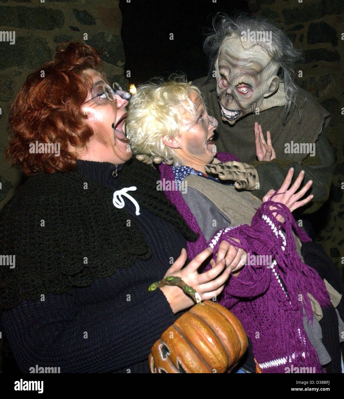 (dpa) - A creepy character scares the living daylights out of two visitors at the Halloween Festival on Frankenstein Castle near Pfungstadt, Germany, 31 October 2002. Stock Photo