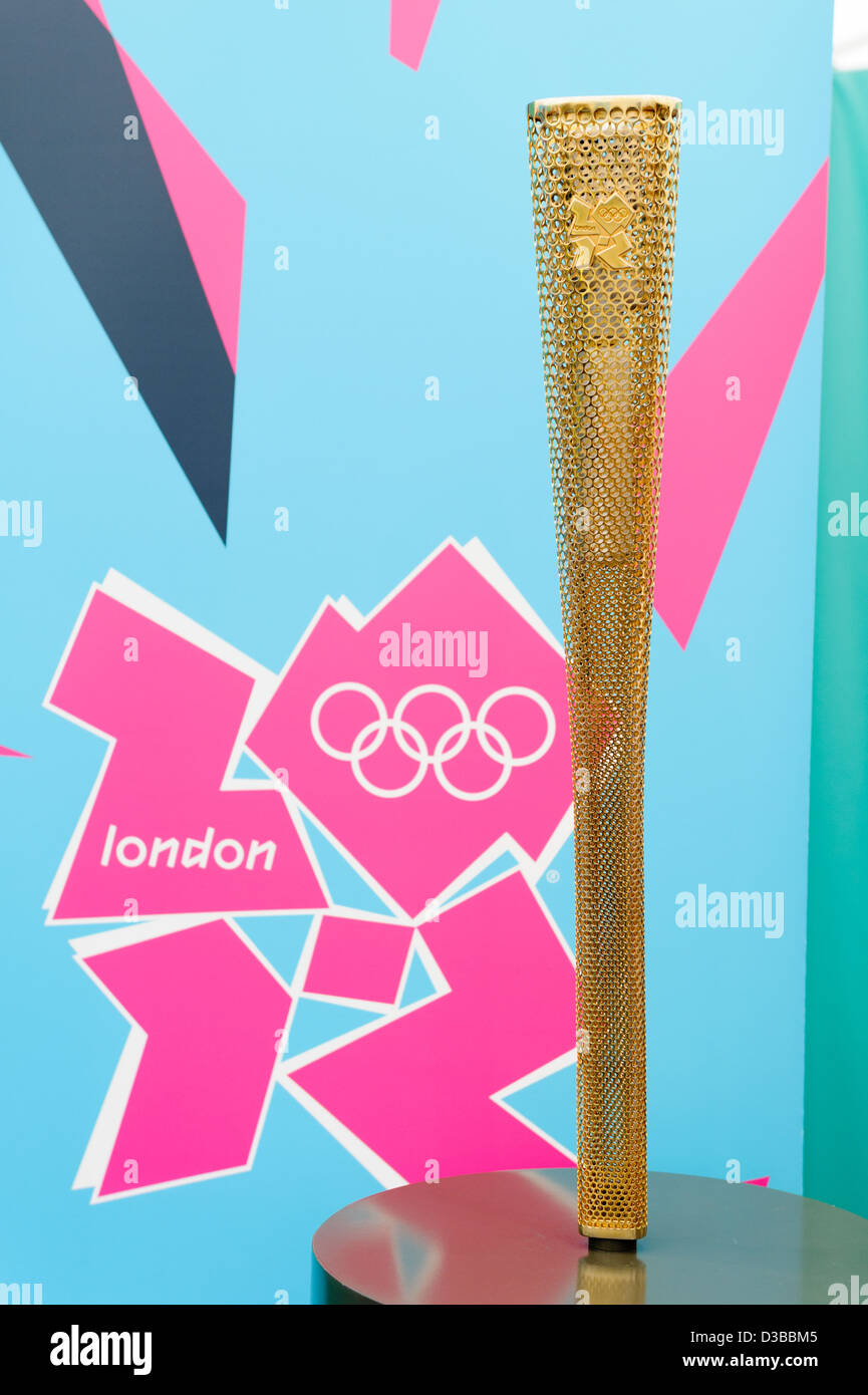 Torch for London 2012 Olympic Games with logo behind. Stock Photo