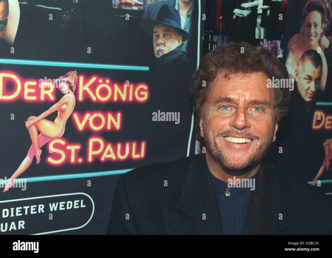 (dpa files) - German film director and script writer Dieter Wedel poses in front of a poster of his television series 'Der Koenig von St Pauli' (the king of St Pauli) in Hamburg, 4 December 1997. Born on 12 November 1942 in Frankfurt, he has become one of Germany's most renowned filmmakers with such Stock Photo