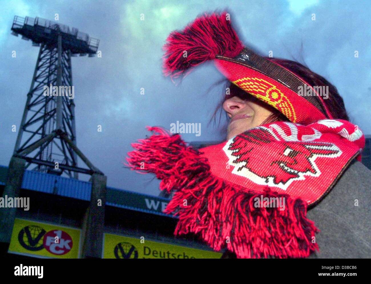 (dpa) - The storm blows the shawl into the face of a female soccer fan in front of the stadium in Kaiserslautern, Germany, 27 October 2002. The soccer match between the Kaiserslautern and Bochum teams was postponed due to the gale-force storms that swept across western Europe. Stock Photo