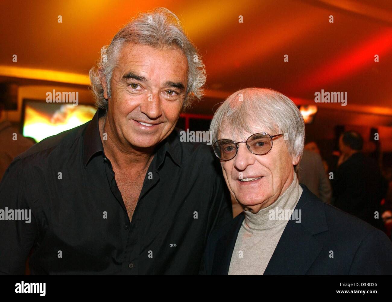 (dpa) - Flavio Briatore of Italy (L), Managing Director of Renault F1 UK , and British Formula One tycoon Bernie Ecclestone enjoy themselves at the Audi party in Kitzbuehel, Austria, 26 January 2003. Stock Photo