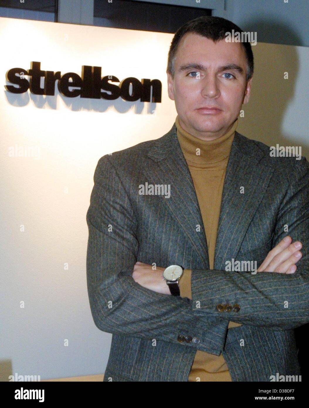 (dpa) - Reiner Pichler, managing director of the fashion company Strellson AG, is posing in front of the corporate logo, Kreuzlingen, Switzerland, 19 December 2002. 112 people are working at the headquarter, worlwide Strellson has 400 employees and 95 stores in 30 countries. Strellson does not publi Stock Photo