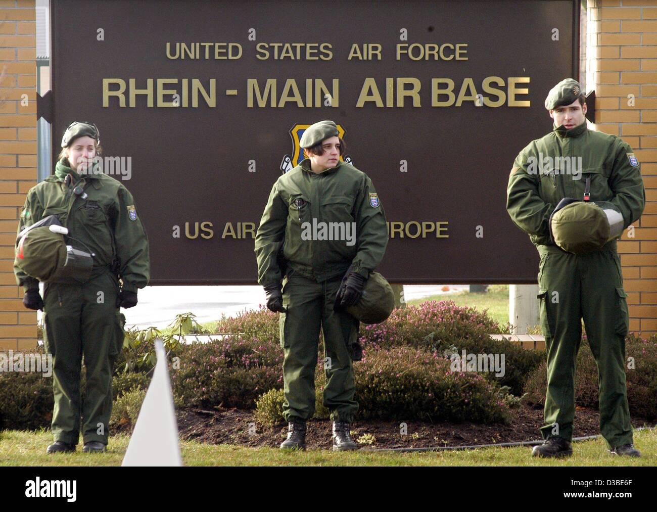 (dpa) - Three German police officers guard the entrance to the Rhein-Main air base of the US army, located just south of the international airport in Frankfurt, 17 January 2003. About 80 demonstrators protesting against US politics on Iraq and against a war in Iraq were blocking the area by sitting  Stock Photo