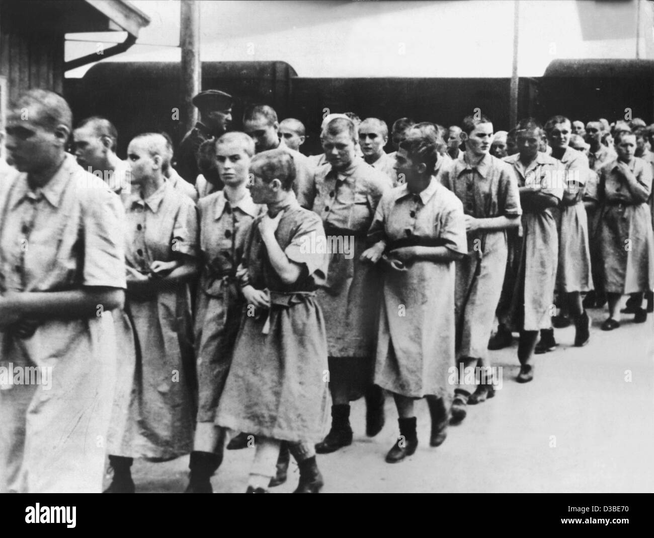 (dpa files) - Female prisoners are led away for slave work in the German Reich, at the Auschwitz concentration camp, near Krakow, Poland (undated filer). The Nazi SS had the concentration camp established in 1940 and enlarged to an extermination camp in 1941. It is believed that 2.5 to 4 million peo Stock Photo