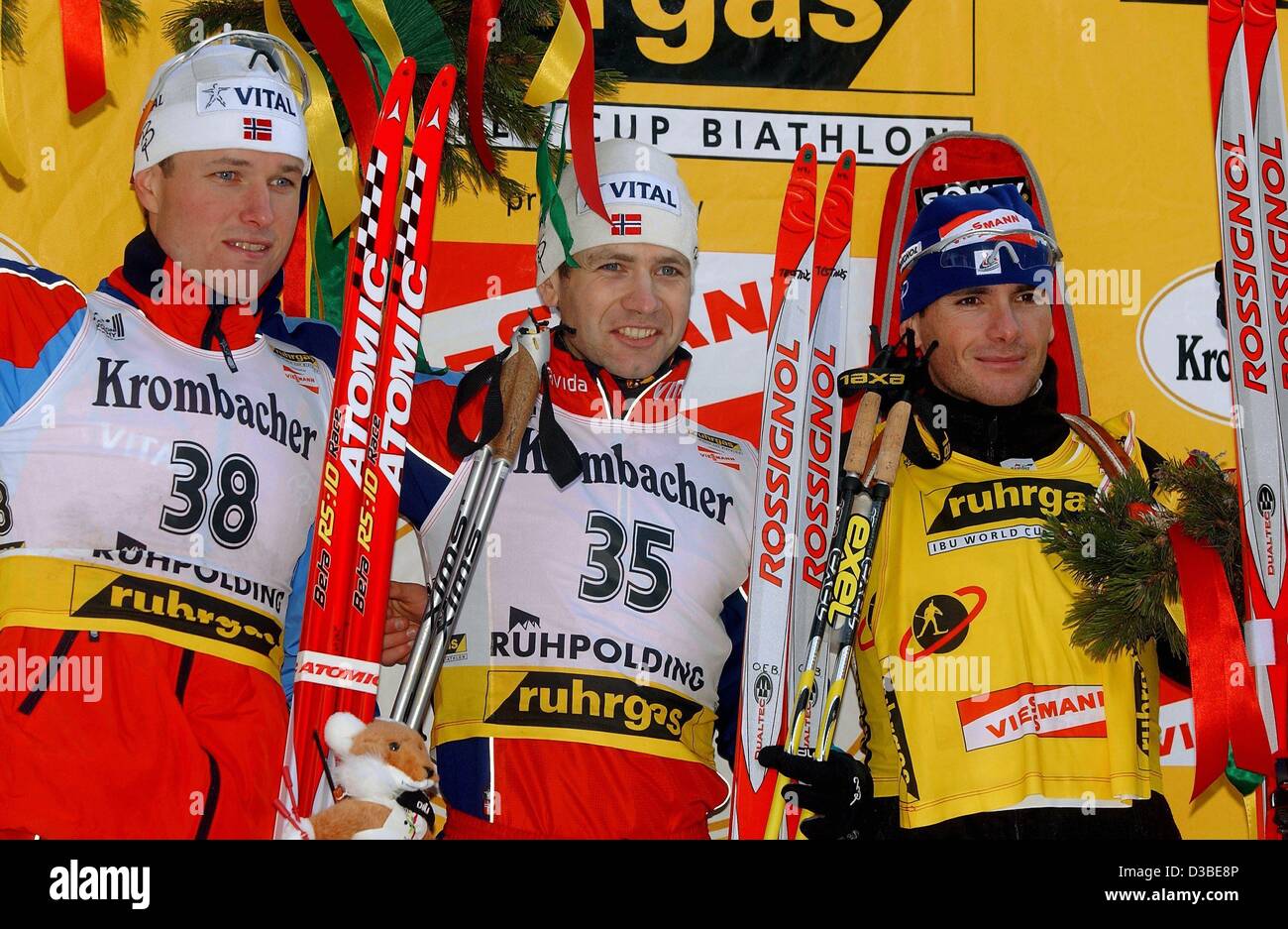 (dpa) - The Norwegian biathlete Ole Einar Bjoerndalen (C) smiles happily with fellow countryman Frode Andresen (L) and Frenchman Raphael Poiree (R) at the Biathlon World Cup awards ceremony for sprinting in Ruhpolding, southern Germany, 18 January 2003.  Olympic champion Bjoerndalen won the 10km spr Stock Photo