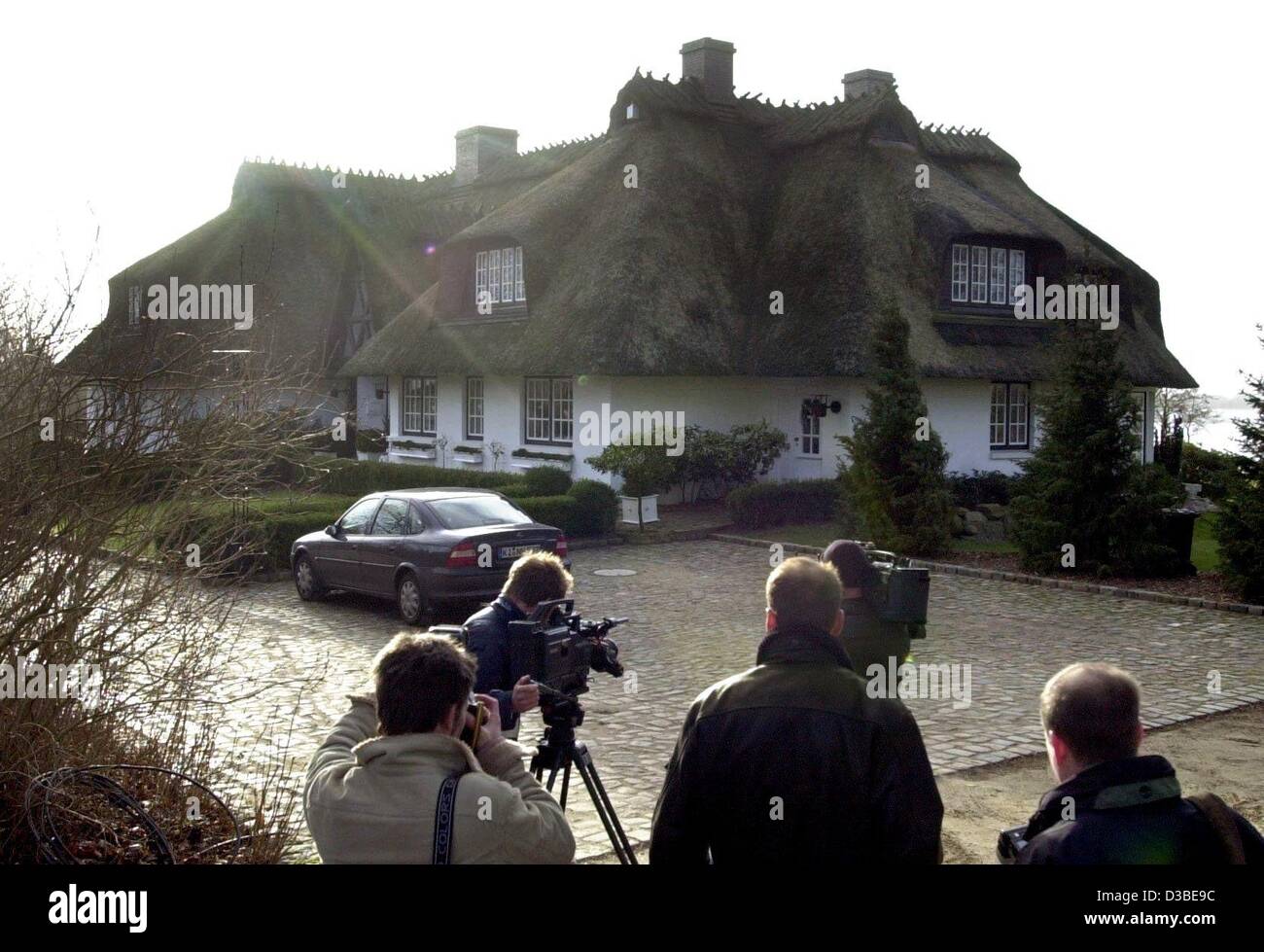 (dpa) - Journalists stand in front of the private home of the founder and majority shareholder of German telecommunication company Mobilcom, Gerhard Schmid, in Luerschau, northern Germany, 16 January 2003. German police and prosecutors on 16 January searched Schmid's private home and his wife's comp Stock Photo