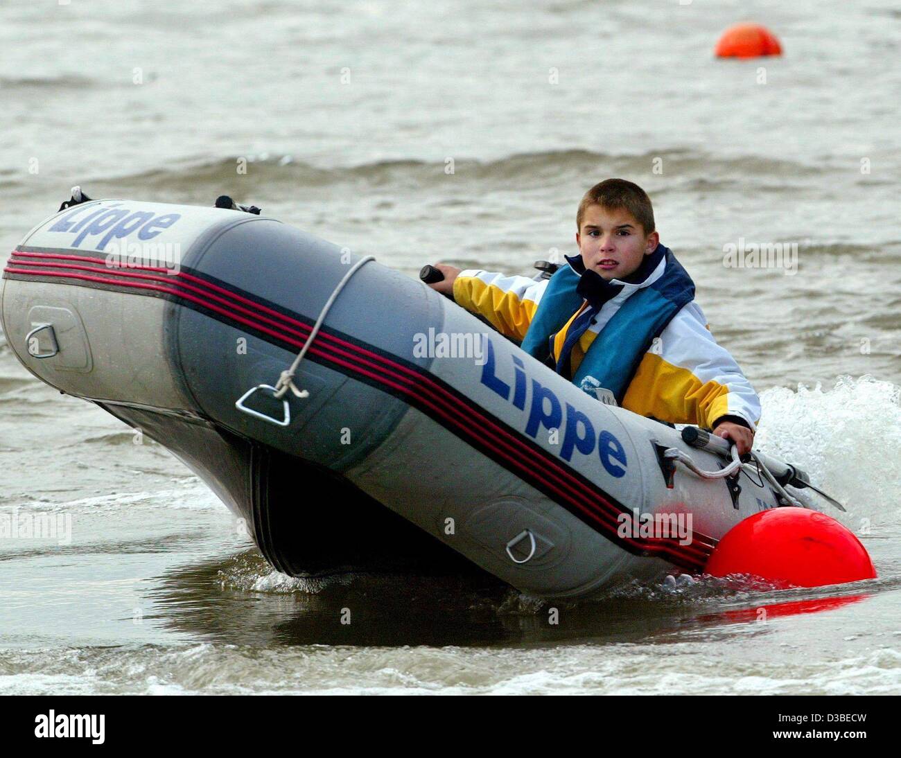(dpa) - 10-year-old Tobias Komm from Dinslaken, Germany, practises manoeuvring his rafting boat in the docks of the River Rhine near Wesel in Germany, 13 January 2003. The surface-marker buoys are close to each other and require quick reflexes from the navigator. Tobias is world champion in his age  Stock Photo