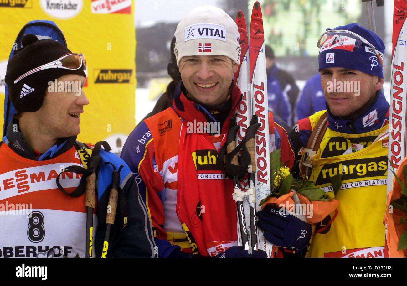 (dpa) - The Norwegian biathlete Ole Einar Bjoerndalen (C) is pleased about his victory in the 15-kilometer mass-start race for men at the Biathlon World Cup in Oberhof, eastern Germany, 12 January 2003.  To the left of Bjoerndalen stands second-place winner Vladimir Dratschev of Belarus.  Raphael Po Stock Photo