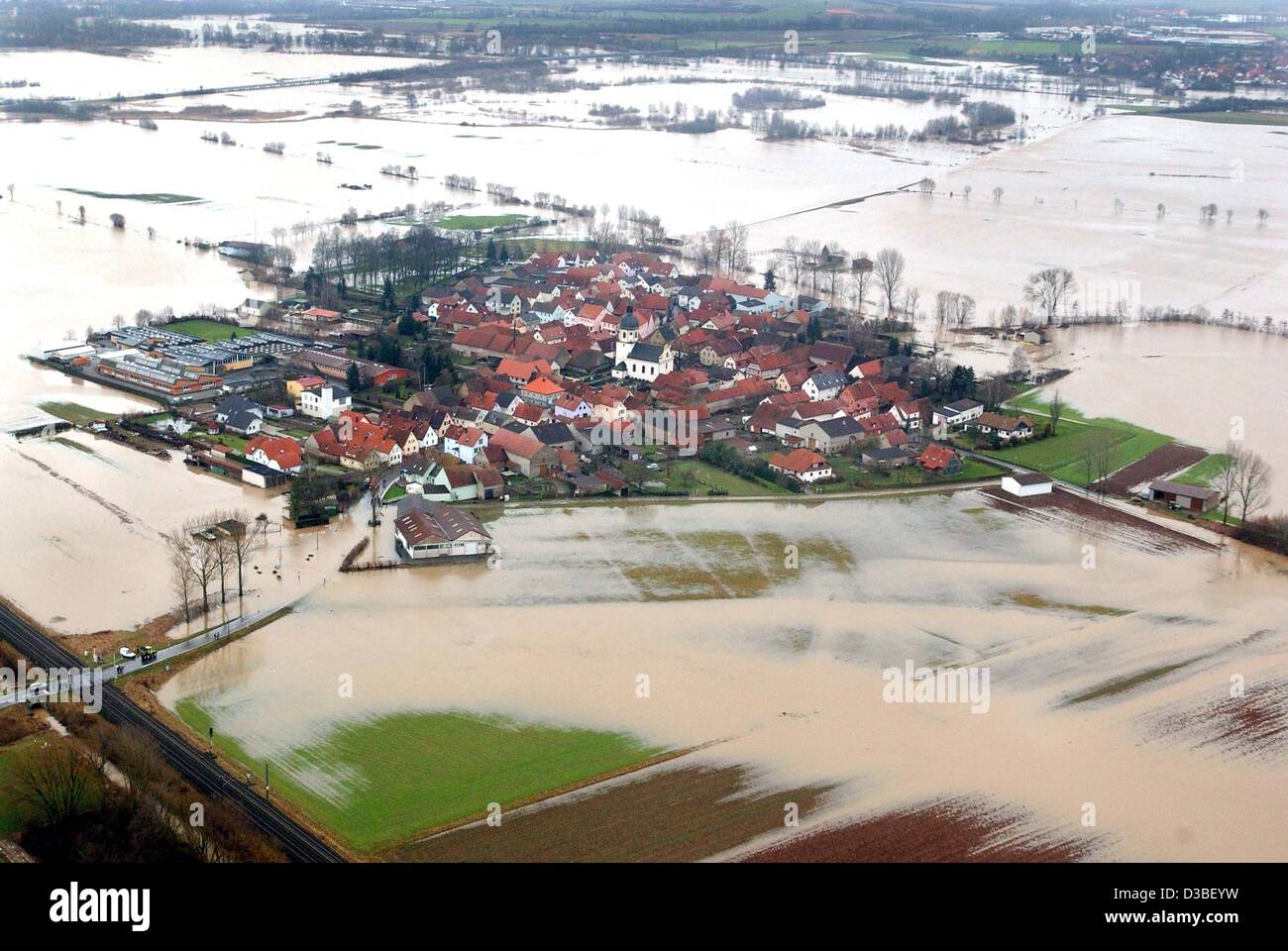 (dpa) - The village of Augsfeld is surrounded by floodwaters in Bavaria, Germany, 4 January 2003. Flood alerts were issued along Germany's main rivers after heavy rain sent water levels surging. But levels are rising slowlier than expected. Stock Photo