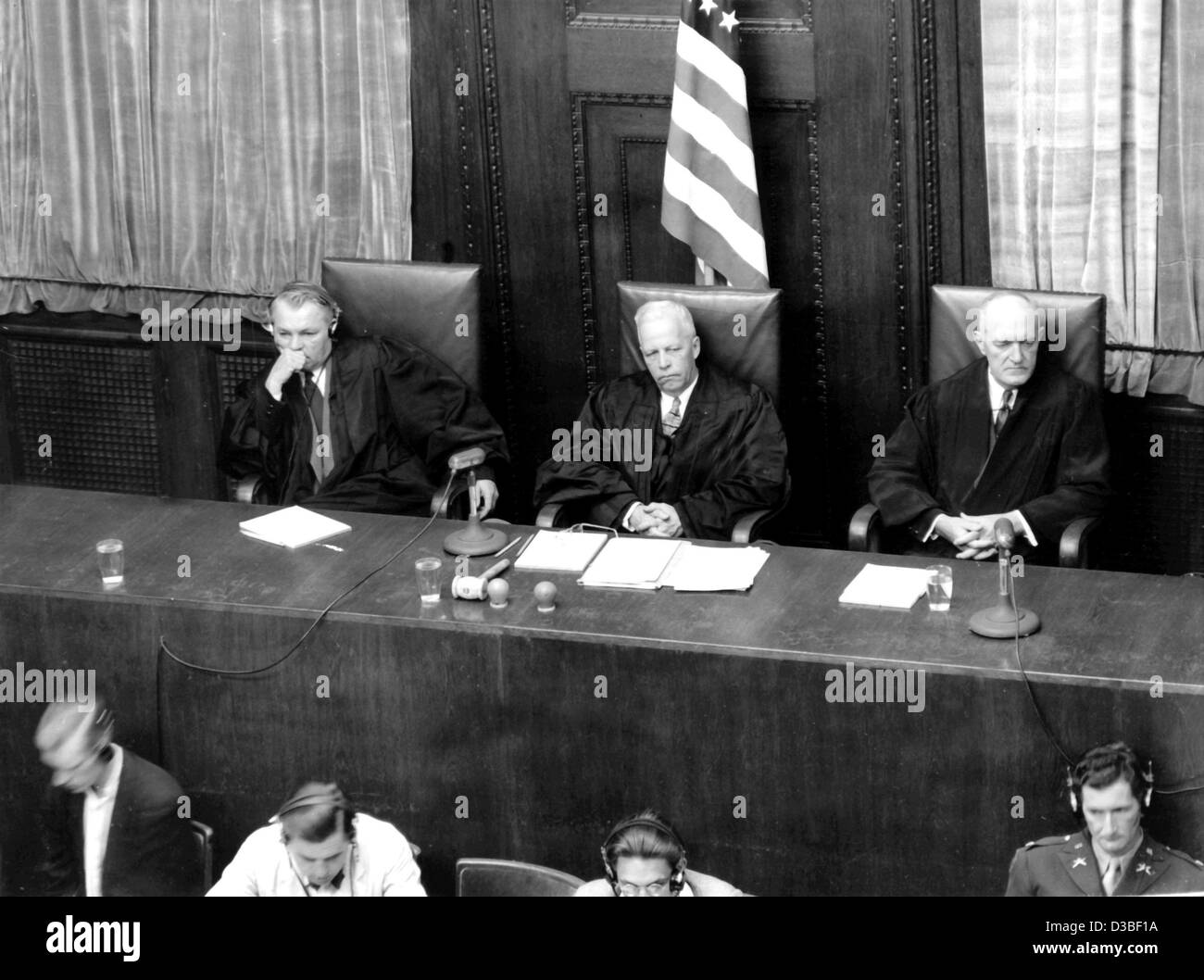(dpa files) - Charles Frederick Wannerstrum (C), Chief Judge of the US Military Tribunal V, and his associate judges, pictured during the Nuremberg Trials, in the court in Nuremberg, Germany, 15 July 1947. On that day the trial against eleven former Generals of the Wehrmacht started. At the end of W Stock Photo