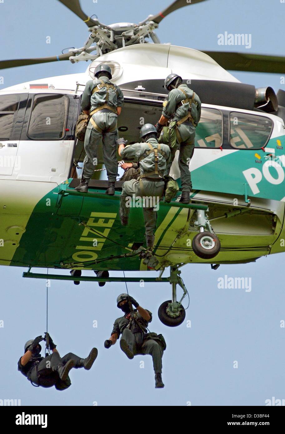 (dpa) - Members of the police special forces (SEK) abseil themselves from an air borne Eurocopter of the type EC-155 during a police exercise near Deggingen, 25 June 2003. Pilots and training units of the police and of the SEK (Sondereinsatzkommando) took part in these exercises. Stock Photo
