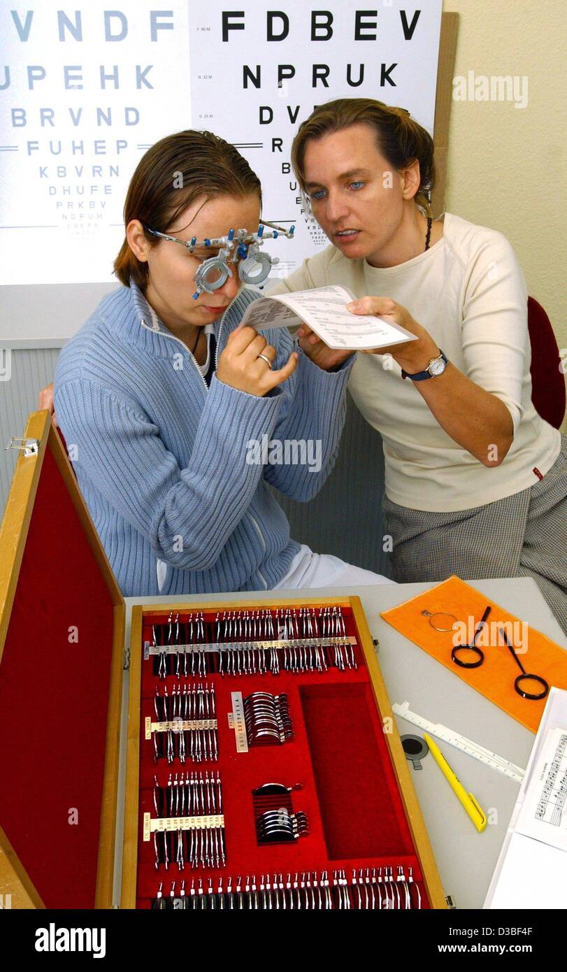 (dpa) - Orthooptist Petra Verweyen (R) conducts a reading test with the prospective masseuse Dayana Schuetze who wears a set of special spectacles at the Centre for the blind and visually impaired people in Chemnitz, Germany, 25 June 2003. The test as part of a diagnosis to adapt a pair of special s Stock Photo