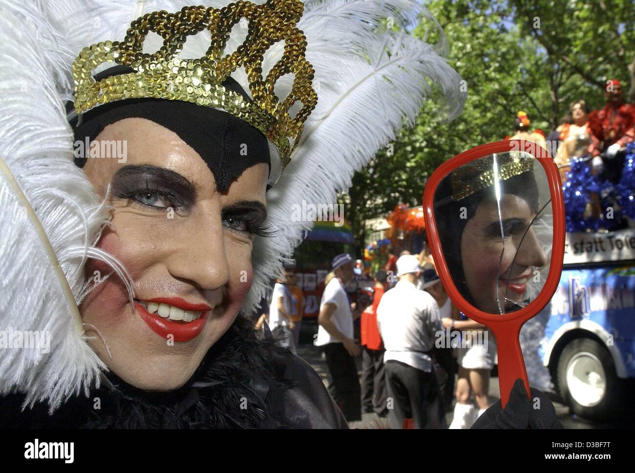 (dpa) - A gay man disguised as 'wicked witch' holds a broken mirror in his hand at the traditional parade of homosexuals on the 25th Christopher Street Day (CSD) in Berlin, 28 June 2003. The motto of this year's CSD was 'acceptance instead of tolerance'. About 600,000 visitors were reported to have  Stock Photo