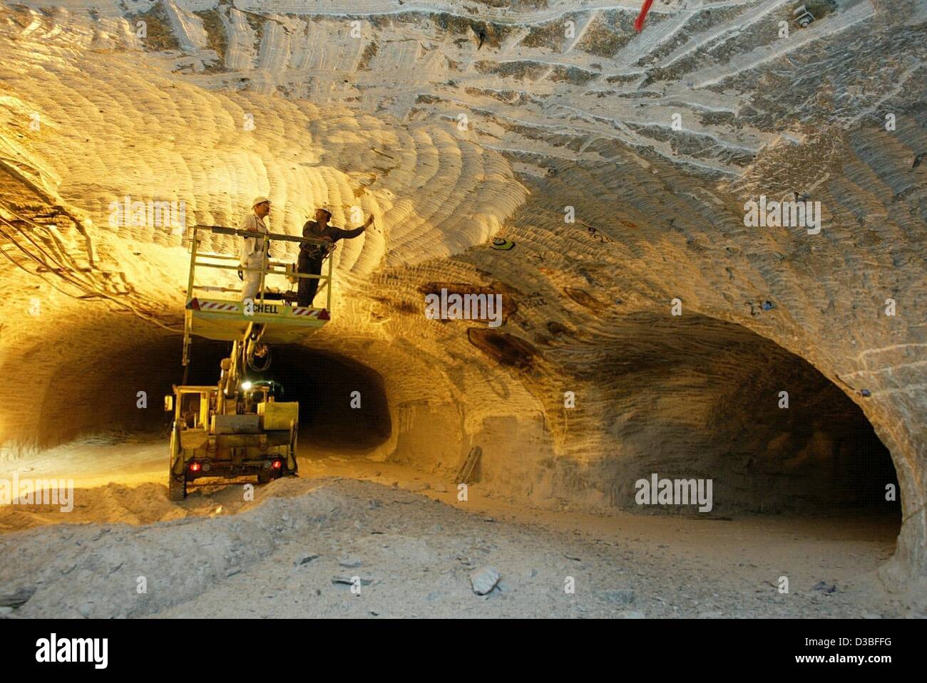 (dpa) Two engineer measure and discuss a crack in the ceiling in one