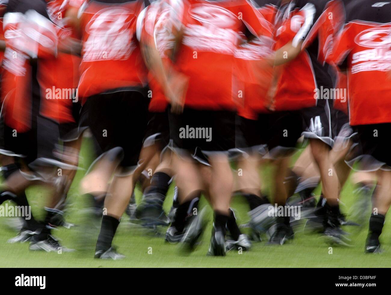 (dpa) - The players of the German soccer club 1st FC Cologne exercise on the pitch during a trainings session in Cologne, Germany, 26 June 2003 (intended effect through long-term exposure). Cologne managed by the end of the last Bundesliga season to ascend to the German premier league and has booste Stock Photo