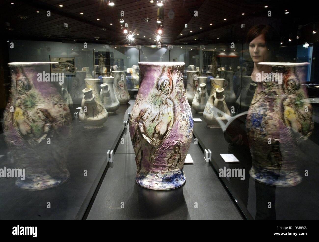 (dpa) - A chagall vase is reflected in the display case as well as a female visitor of the Chagall exhibition in Balingen, Germany, 18 June 2003. About 100 pieces of pottery are presented until 28 September 2003. Stock Photo