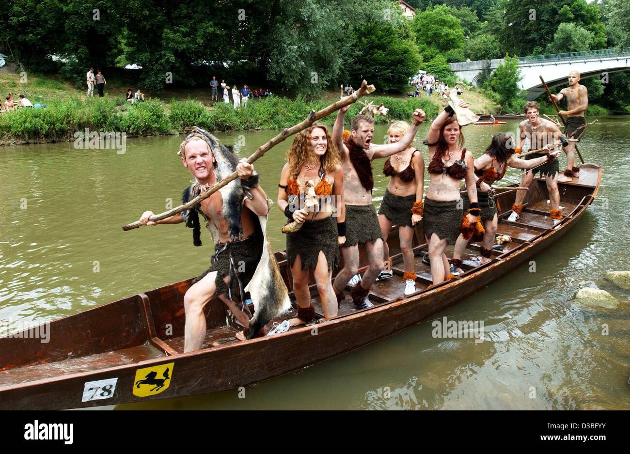 (dpa) - Students, dressed in stone age costumes, gesture their primeval will and energy to win the 48th annual punt race in Tuebingen, Germany, 19 June 2003. Thousands of spectators watch the event during which the participants have to circumnavigate a small island on the River Neckar. However, ther Stock Photo