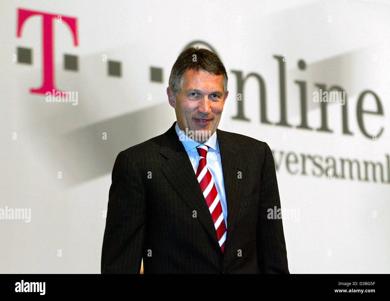 (dpa) - Thomas Holtrop, Chief Executive Officer of the German internet provider T-Online International, stands in front of the company logo during the general meeting in Cologne, Germany, 21 May 2003. T-Online's main market is Germany, followed by France, Spain, Austria and Switzerland. Stock Photo