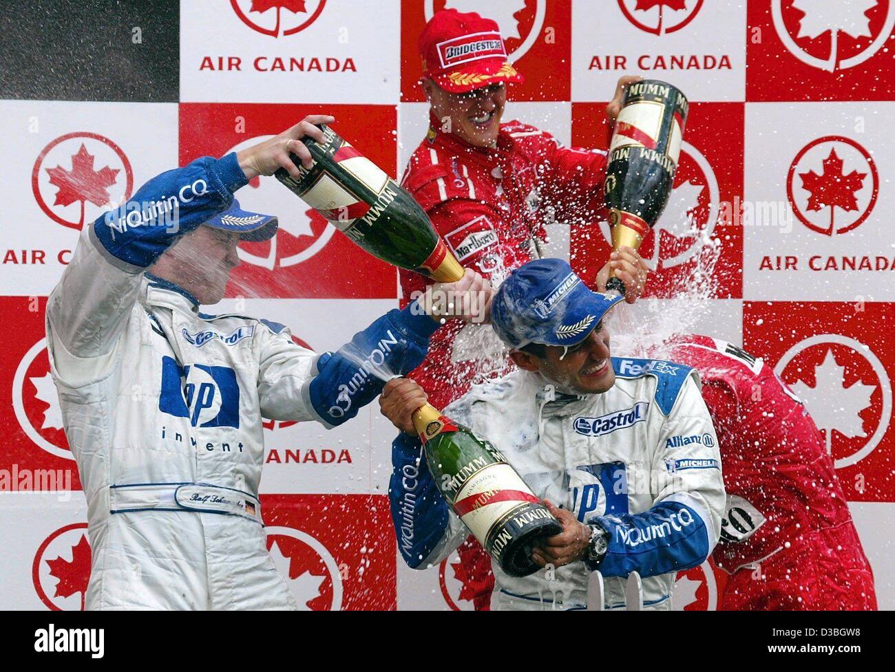 (dpa) - German formula one world champion Michael Schumacher (Ferrari) (back, 2nd from L), hids brother Ralf (MW-Williams) (L) and the Columbian pilot Juan Pablo Montoya (front, C) (MW-Williams) splatter each other with sparkling wine during the award ceremony on the Circuit Gilles Villeneuve formul Stock Photo